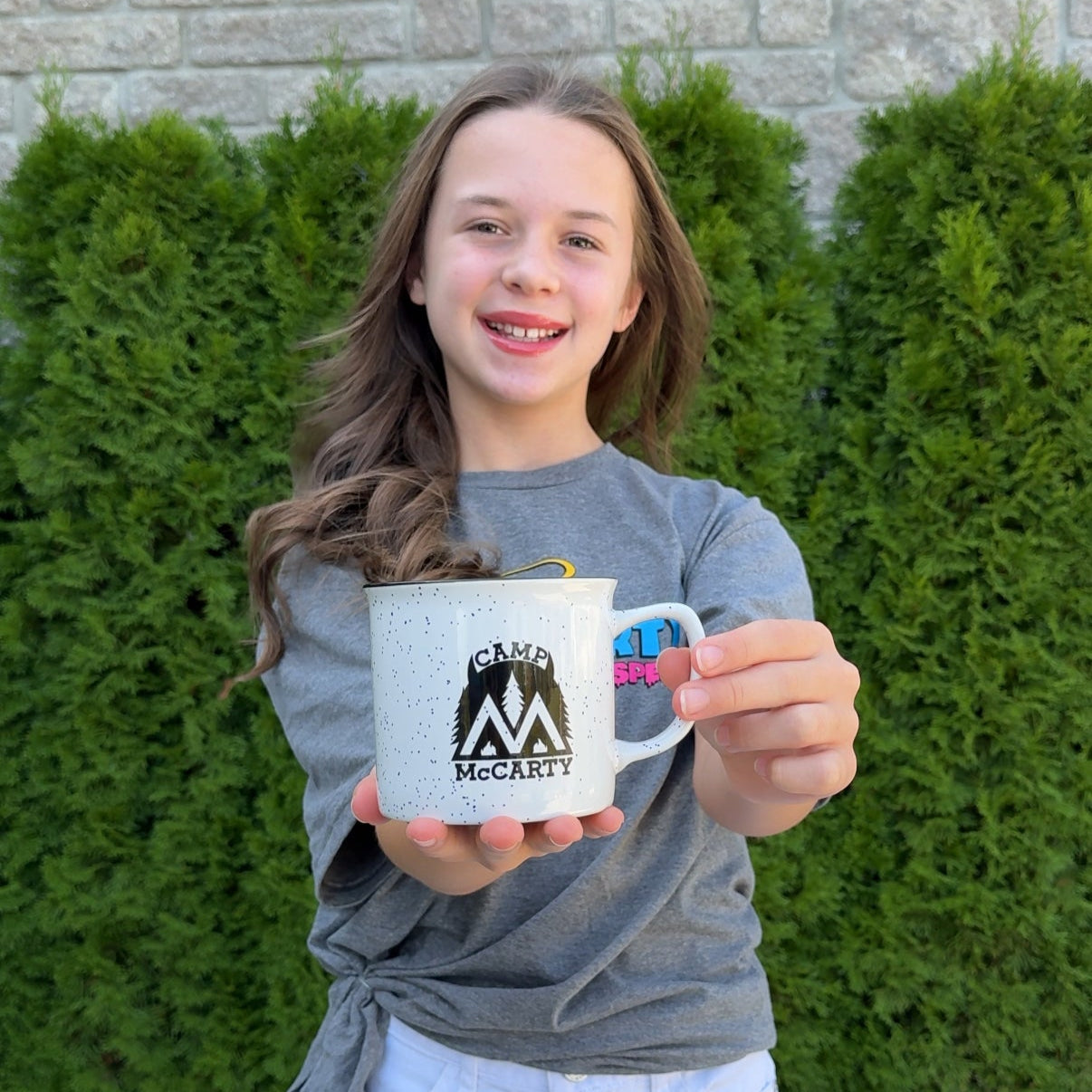 Audri holding the Camp McCarty Mug