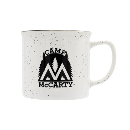 White mug with black speckles featuring 'Camp McCarty' logo on a white background