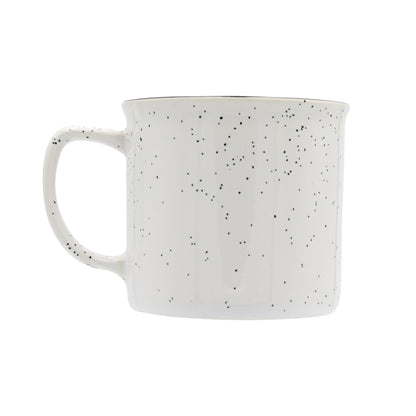 White ceramic mug with black speckles on a white background